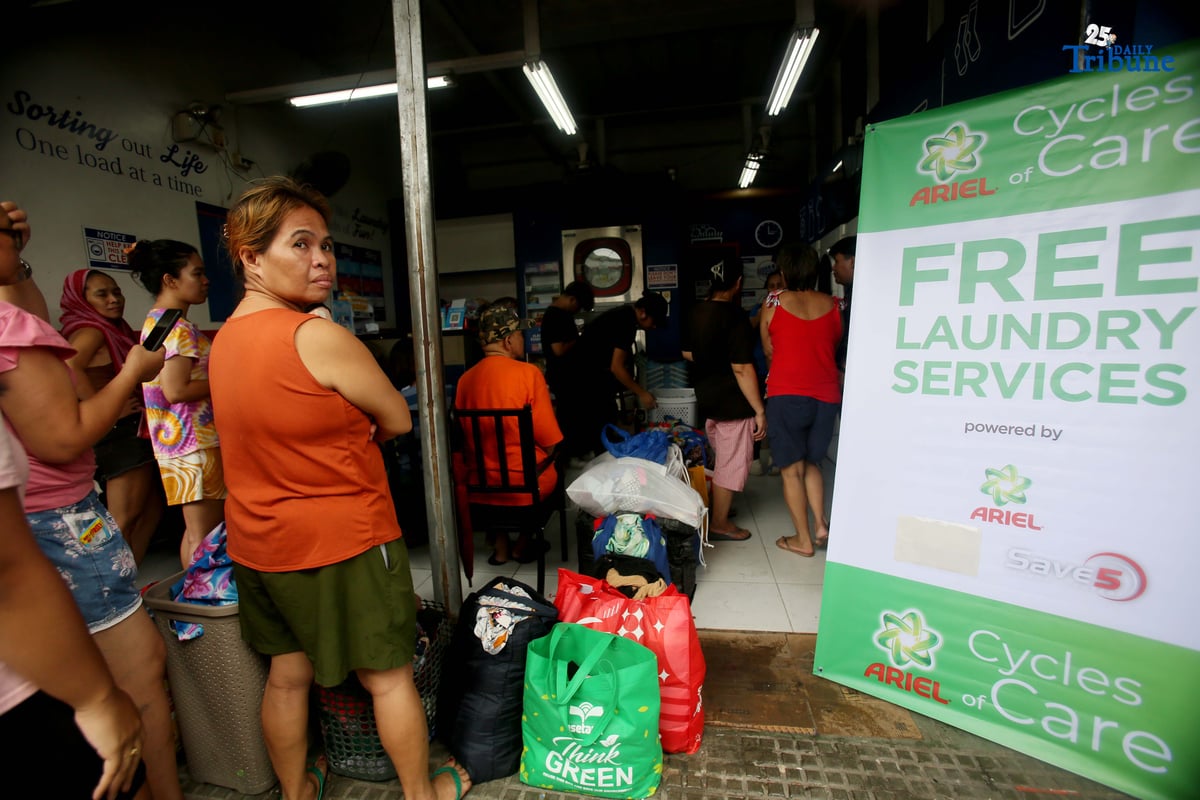Residents near Nega-Qmart in Cubao, Quezon City, line up to avail of free laundry services at Save5 laundry center, part of Ariel Philippines' “Cycles of Care” initiative. The three-week relief program offers complimentary laundry services to families affected by recent typhoons and habagat rains across 30 branches in Metro Manila, in partnership with Save5.