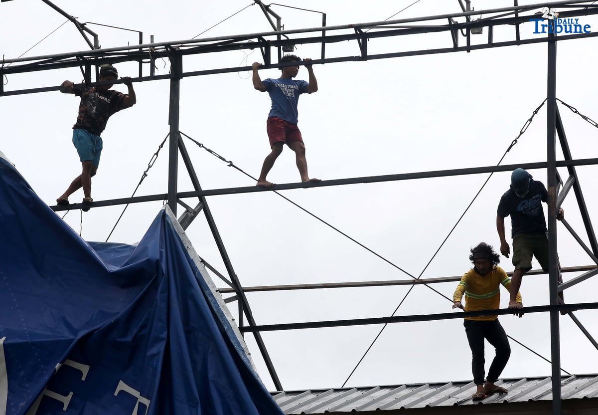 Workers were seen untying an outdoor advertisement along Commonwealth Avenue in Quezon City on Saturday morning. In a briefing past 5 AM, the Philippine Atmospheric, Geophysical, and Astronomical Services Administration (PAGASA) reported that Tropical Storm Emong (Co-may) weakened into a tropical depression as of 2 AM and exited the Philippine Area of Responsibility (PAR) at 7:10 AM.