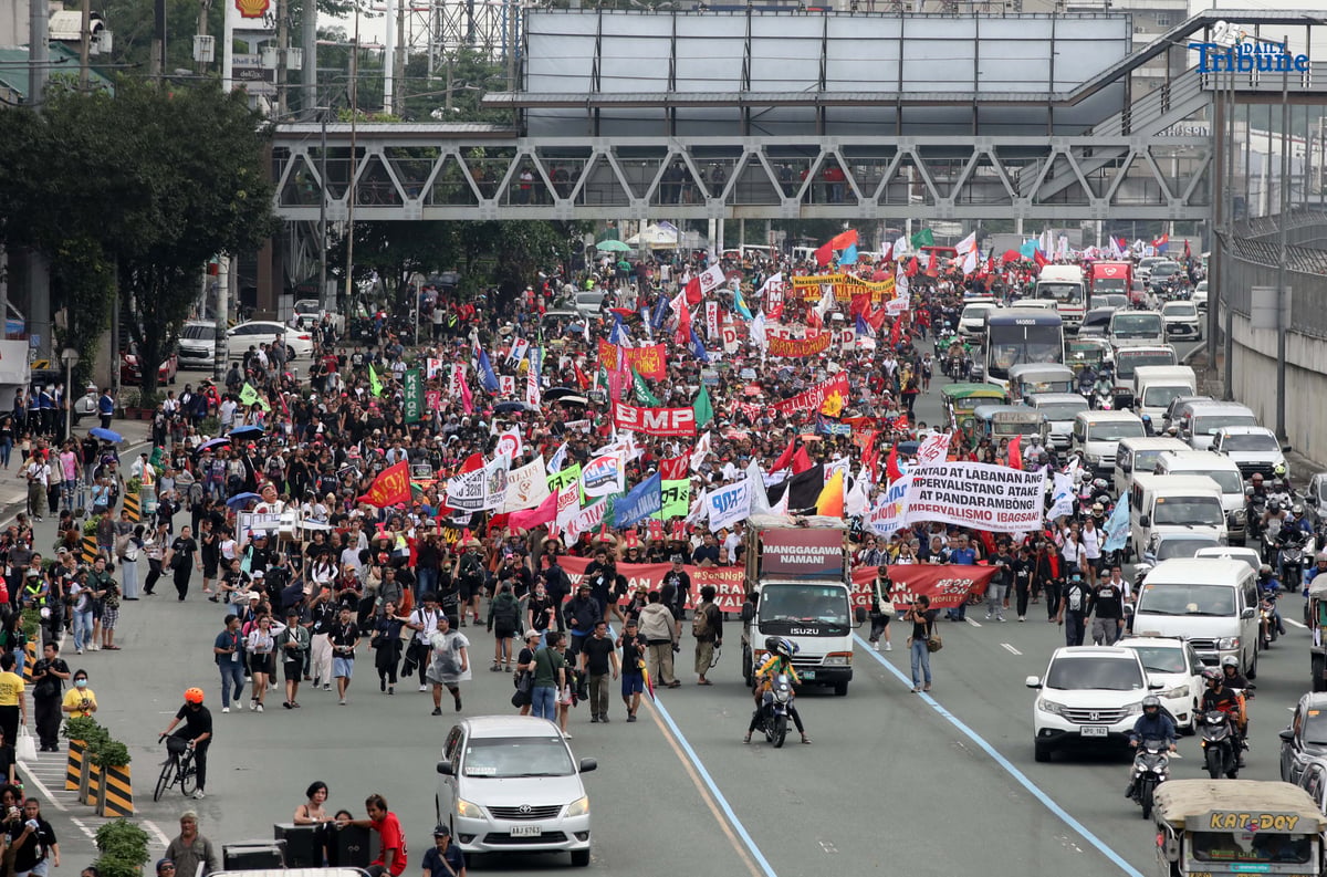 Thousands of protesters from militant groups march along Commonwealth Avenue in Quezon City toward St. Peter Parish Church to stage a SONA protest themed “SONA ng Paniningil,” coinciding with President Ferdinand Marcos Jr.’s fourth State of the Nation Address.