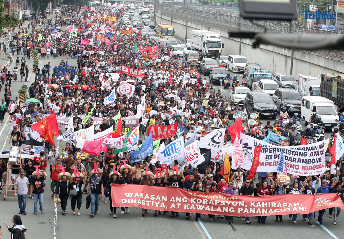 Thousands of protesters from militant groups march along Commonwealth Avenue in Quezon City toward St. Peter Parish Church to stage a SONA protest themed “SONA ng Paniningil,” coinciding with President Ferdinand Marcos Jr.’s fourth State of the Nation Address.