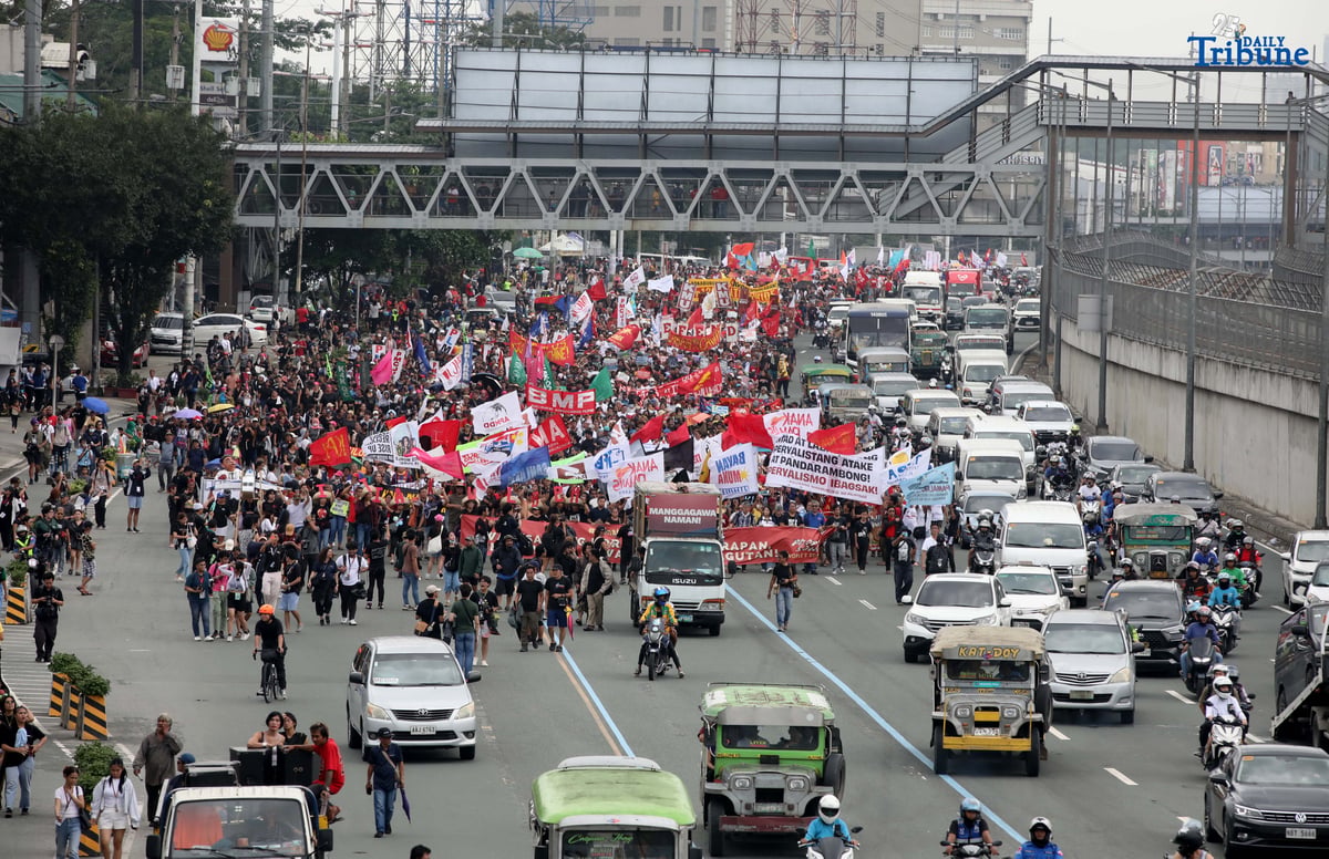 Thousands of protesters from militant groups march along Commonwealth Avenue in Quezon City toward St. Peter Parish Church to stage a SONA protest themed “SONA ng Paniningil,” coinciding with President Ferdinand Marcos Jr.’s fourth State of the Nation Address.