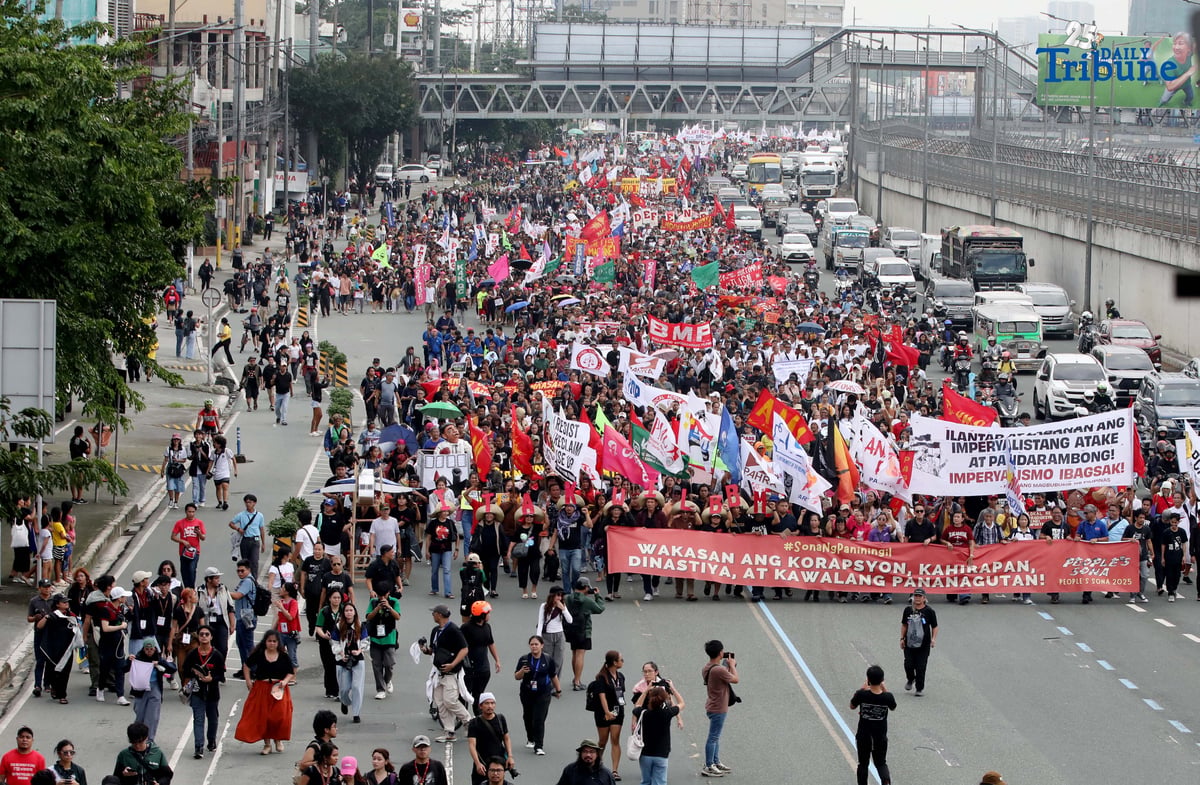Thousands of protesters from militant groups march along Commonwealth Avenue in Quezon City toward St. Peter Parish Church to stage a SONA protest themed “SONA ng Paniningil,” coinciding with President Ferdinand Marcos Jr.’s fourth State of the Nation Address.