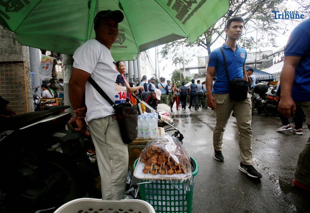 A vendor sells food and water outside St. Peter Church in Quezon City during the fourth State of the Nation Address of President Ferdinand Marcos Jr. on Monday, July 28, 2025.