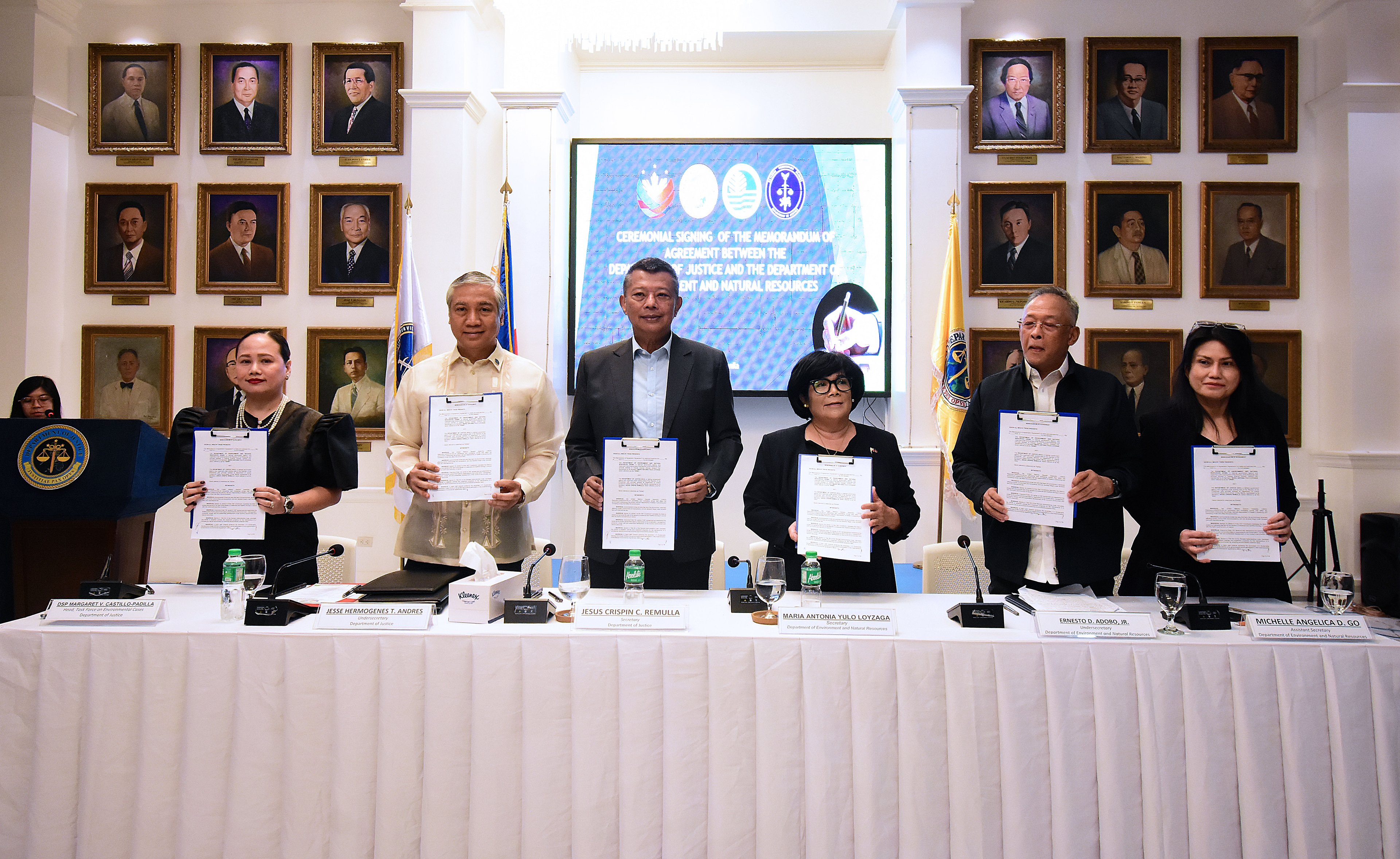 SOJ Remulla (3rd from left) and SENR Maria Antonia Yulo-Loyzaga (4th from left) proudly present the  signed copy of the MOA between the DOJ-DENR aimed at strengthening the investigation and prosecution of environmental crimes