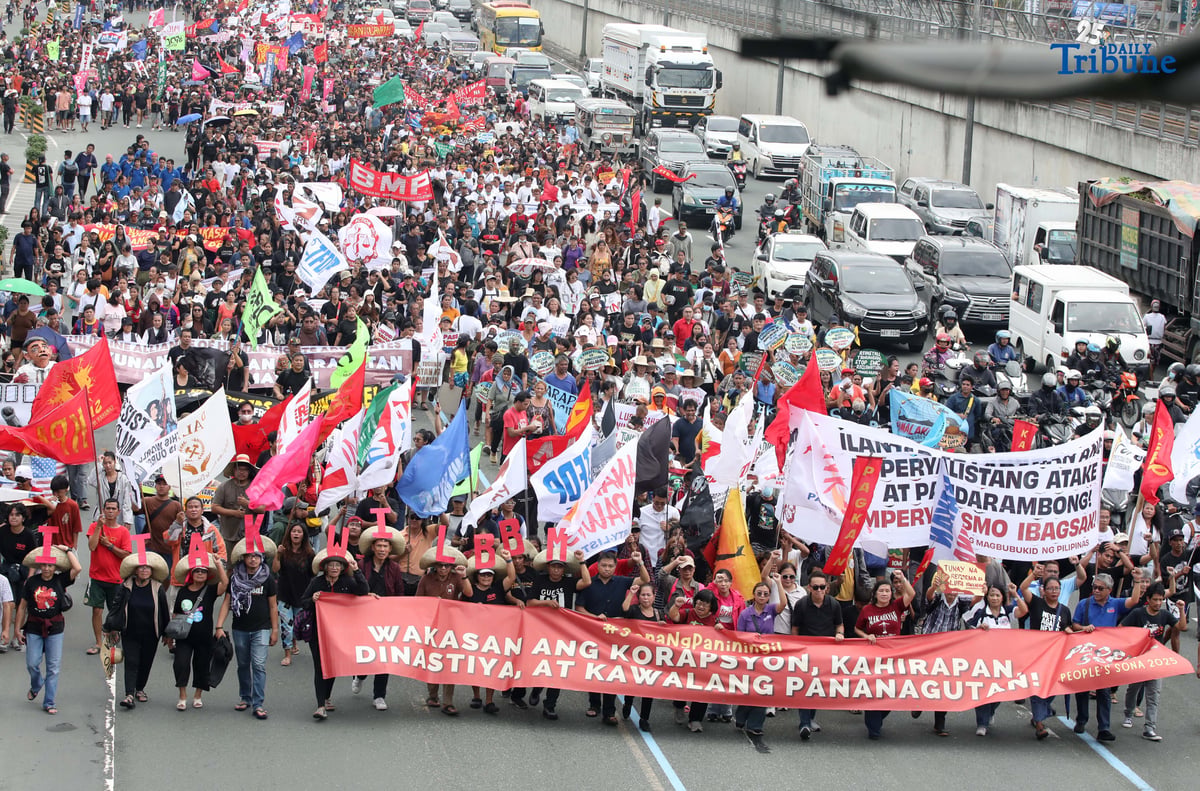 Thousands of protesters from militant groups march along Commonwealth Avenue in Quezon City toward St. Peter Parish Church to stage a SONA protest themed “SONA ng Paniningil,” coinciding with President Ferdinand Marcos Jr.’s fourth State of the Nation Address.