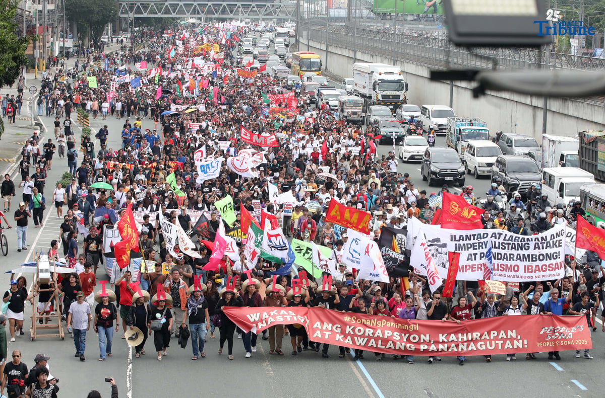 Thousands of protesters from militant groups march along Commonwealth Avenue in Quezon City toward St. Peter Parish Church to stage a SONA protest themed “SONA ng Paniningil,” coinciding with President Ferdinand Marcos Jr.’s fourth State of the Nation Address.
