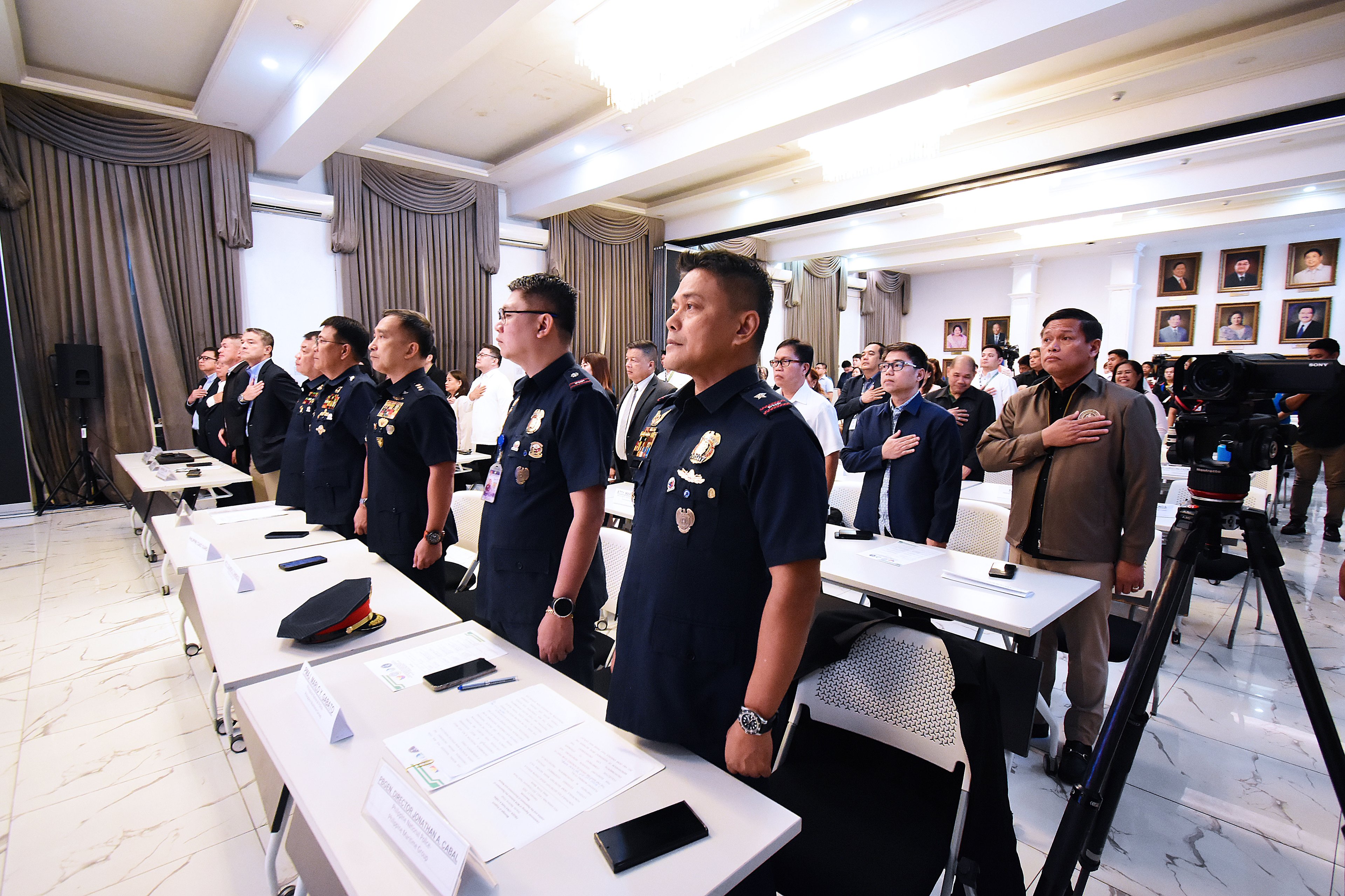 POLICE officers and DOJ officials sing the National Anthem during the launching of the Training and Education Program for DOJ Prosecutors and Law Enforcement Agents (TEPLEA).