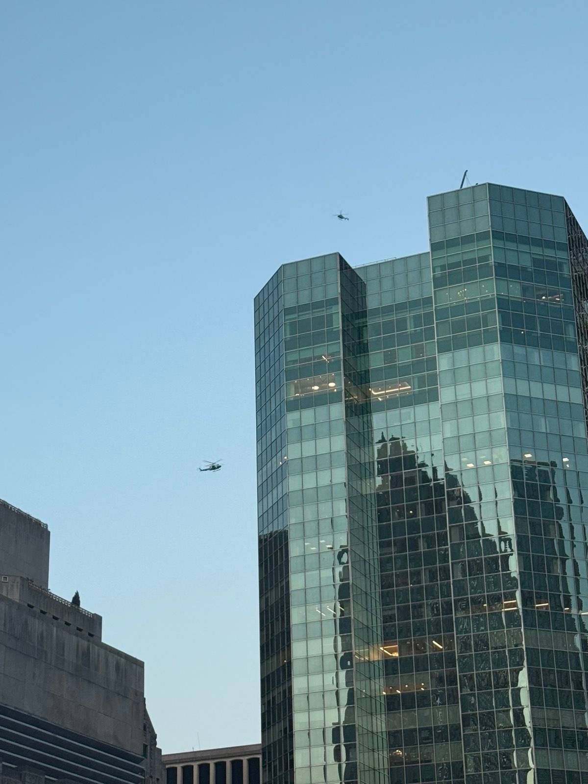 Helicopters are still flying over the scene.