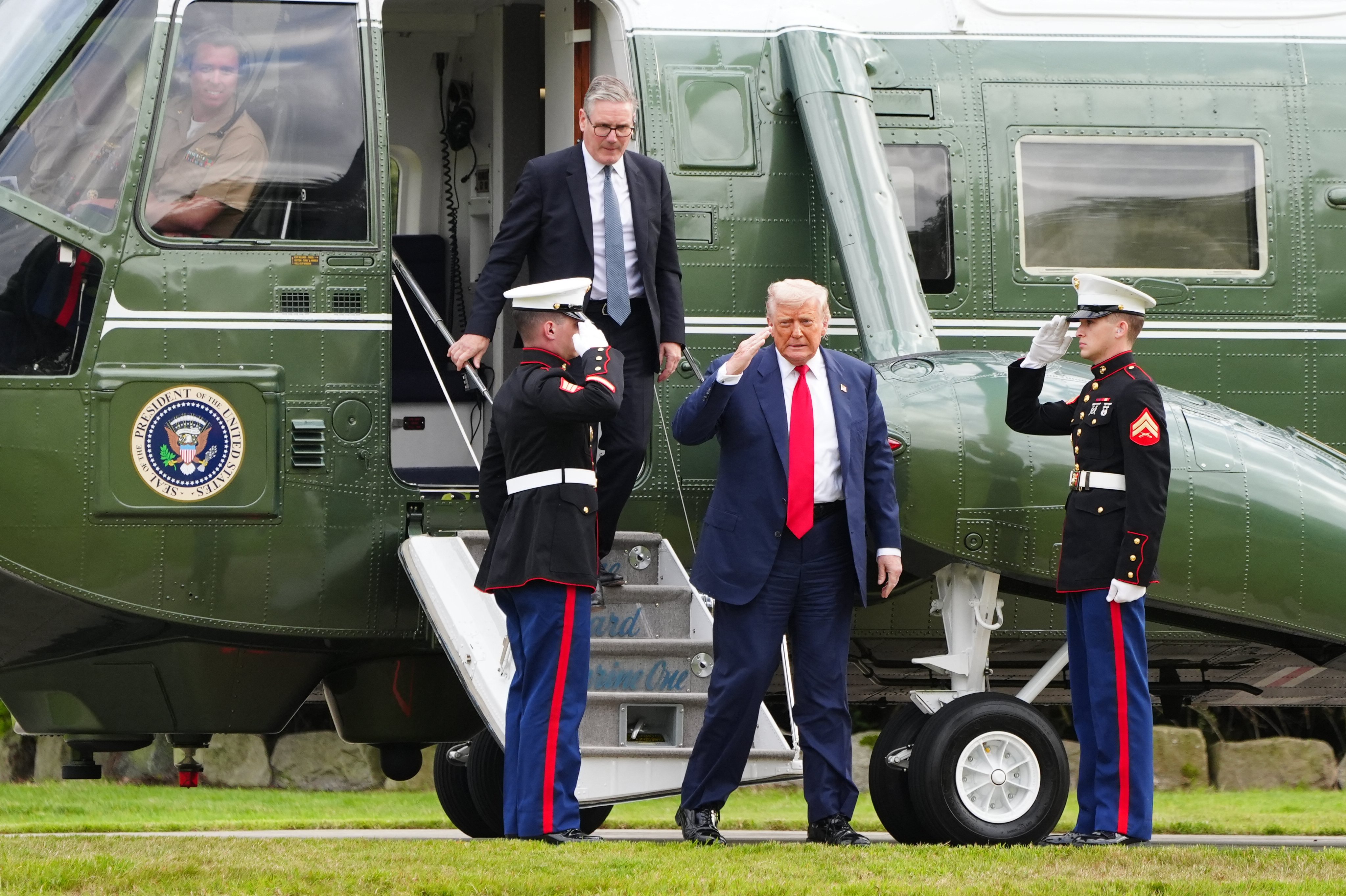 US President Donald Trump (front) and Britain’s Prime Minister Keir Starmer (back) disembark Marine One at Trump MacLeod House & Lodge Trump on the Trump International Estate in Balmedie, Aberdeenshire, north east Scotland.