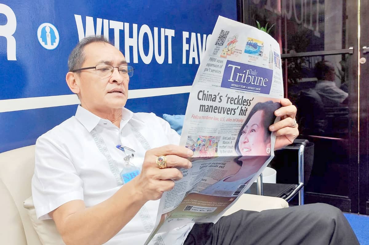 Hot off the press NBI Director Jaime Santiago pauses amid headlines, diving into the day’s truth at the TRIBUNE newsroom.