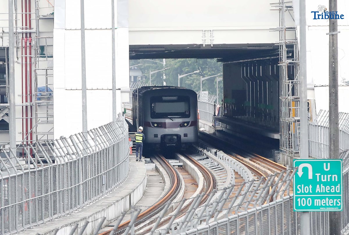 A Metro Rail Transit Line 7 (MRT-7) train is seen parked at Don Antonio Station along Commonwealth Avenue in Quezon City on Monday, July 28, 2025. The 22-kilometer elevated railway connecting Metro Manila to Bulacan via Commonwealth Avenue is expected to begin trial runs by the end of 2025, according to operator San Miguel Corporation.