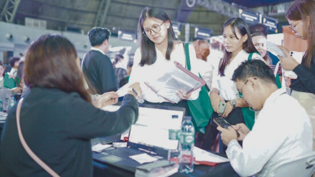 A jobseeker reviews the job requirements from an employer at the PMAP Career Fair, with opportunities available in retail, finance, healthcare, IT and more.