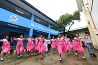 STUDENTS and teachers of Buttong Integrated School welcome their new SM-donated classrooms with joy and pride.