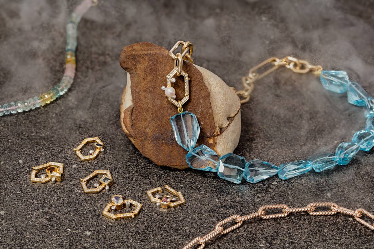 Essence necklace of blue topaz with link chain necklace and Mirabella lock.