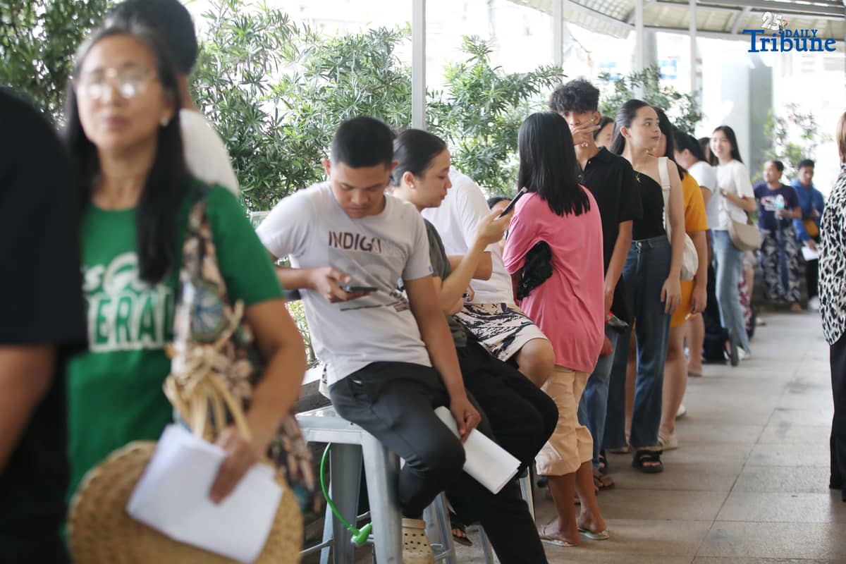Residents line up at a satellite voters' registration center in Barangay Commonwealth, Quezon City on Tuesday in preparation for the upcoming Barangay and Sangguniang Kabataan Elections (BSKE).
