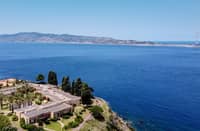 A general aerial view shows the Sicilian coast towards Cape Torre Faro, over the Strait of Messina, taken from the outskirts of the town of Scilla, in Calabria region in southern Italy, on July 7, 2020. Italy's government on August 6, 2025 approved a 13.5-billion-euro ($15.6-billion) project to build the world's longest suspension bridge connecting the island of Sicily to the mainland.