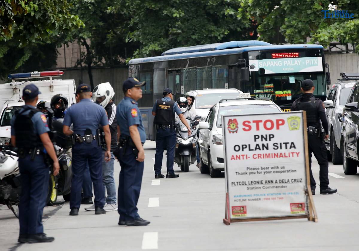 Quezon City Police District (QCPD) Station 10 personnel conduct a checkpoint along NIA Road, Quezon City, on Wednesday, August 6, 2025, as part of the Philippine National Police’s “Plan Sita” anti-criminality operations. According to the QCPD, crime volume in the city dropped by at least 25 percent in the past three months, with 394 recorded incidents from April 21 to July 20, compared to 526 during the same period last year.