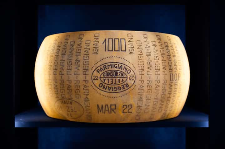 A form of Parmigiano Reggiano cheese is pictured at a stand of the Slow Food Salone del Gusto and Terra Madre in Turin on September 26, 2024. US President Donald Trump ordered the reimposition of tariffs on dozens of trading partners on July 31, 2025 -- his cornerstone strategy for reshaping global trade to benefit the US economy. However in a minor reprieve, the White House said the measures will take effect in a week, not on August 1 as previously expected.