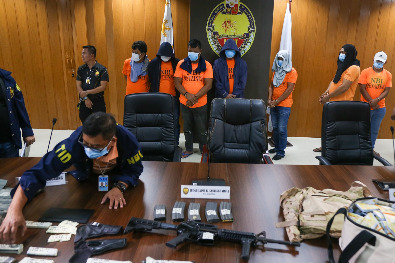 San Simon Mayor Abundio Punsalan Jr., along with his security detail, is presented by the National Bureau of Investigation in Pasay City on 7 August 2025. They were arrested Tuesday night in an entrapment operation over allegations of extortion. The mayor allegedly accepted an initial bribe of ₱30 million in exchange for a favorable local government resolution.