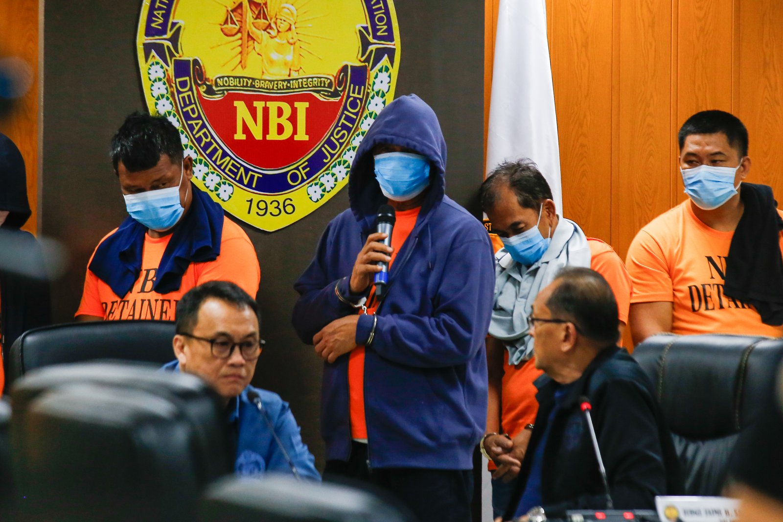 San Simon Mayor Abundio Punsalan Jr., along with his security detail, is presented by the National Bureau of Investigation in Pasay City on 7 August 2025. They were arrested Tuesday night in an entrapment operation over allegations of extortion. The mayor allegedly accepted an initial bribe of ₱30 million in exchange for a favorable local government resolution.