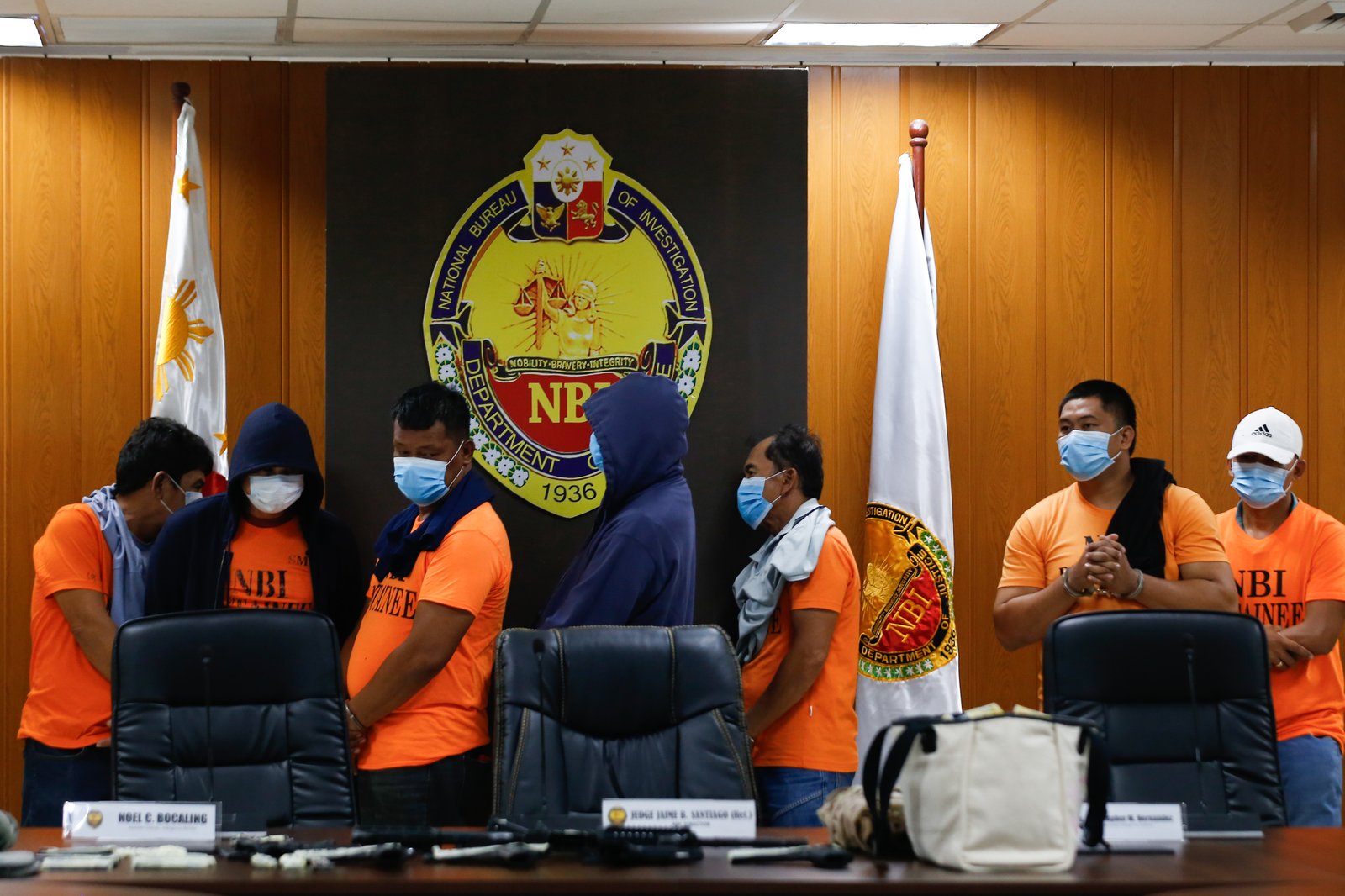 San Simon Mayor Abundio Punsalan Jr., along with his security detail, is presented by the National Bureau of Investigation in Pasay City on 7 August 2025. They were arrested Tuesday night in an entrapment operation over allegations of extortion. The mayor allegedly accepted an initial bribe of ₱30 million in exchange for a favorable local government resolution.