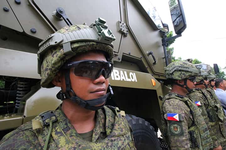 A crew of the High Mobility Artillery Rocket System (HIMARS) stand in attention during a static display at the Fort Magsaysay in Nueva Ecija.