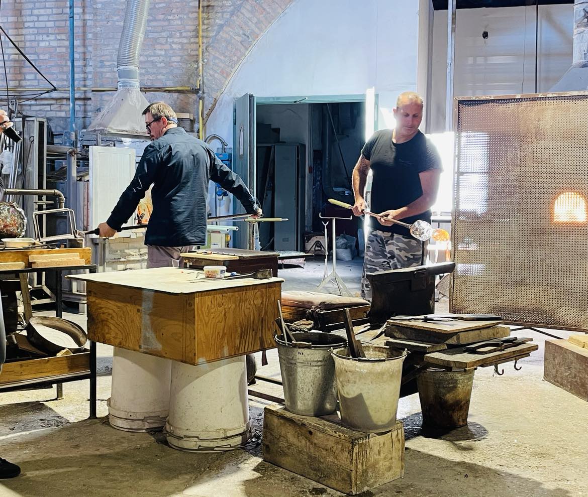 Italian glass artists from a long line of glass makers at work in their factory in Murano Island, Italy.