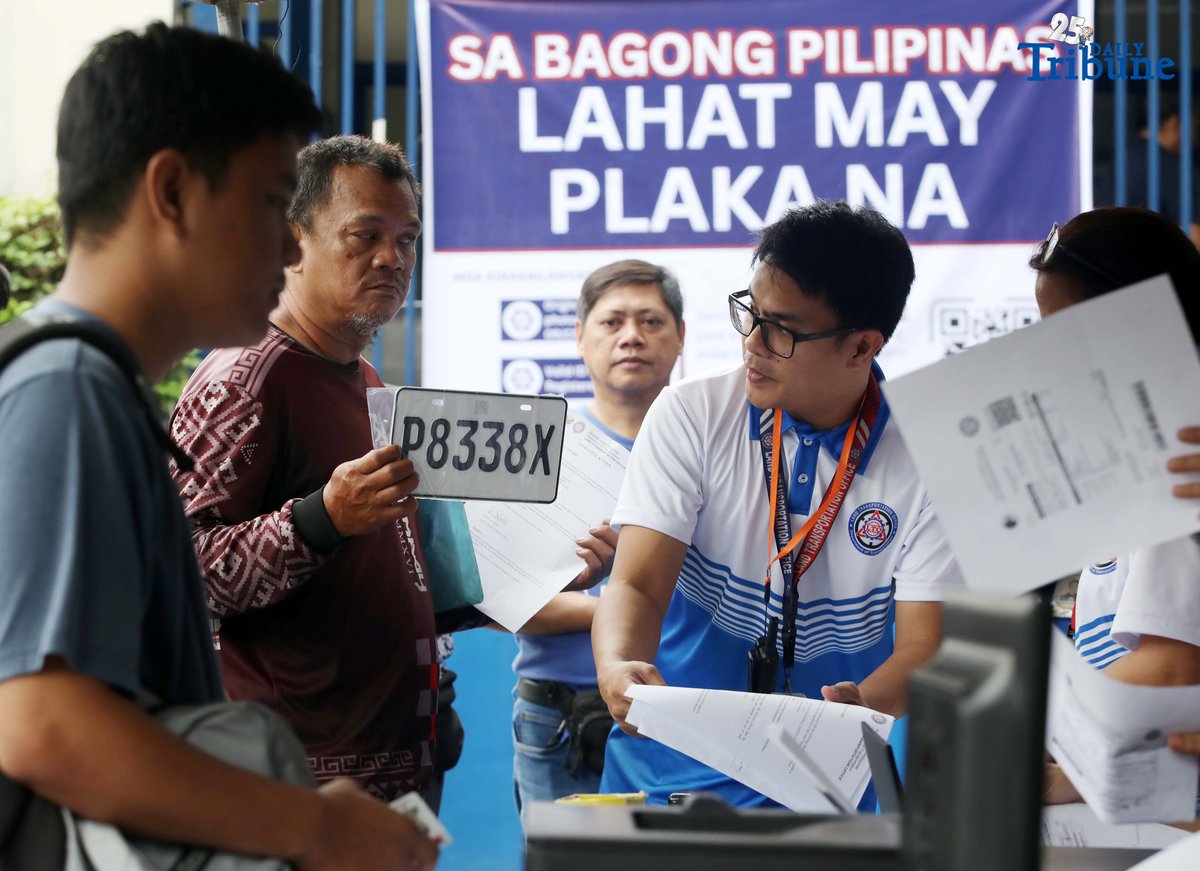 The Land Transportation Office Law Enforcement Unit assists motorcycle owners queuing for the LTO Palit Plaka program at the LTO main office along East Avenue in Quezon City on Saturday. The nationwide plate distribution program aims to address the backlog and ensure motorists comply with registration requirements.