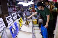 Spike in rice prices A vendor scoops rice at a Manila market as concerns grow over a 60-day rice import suspension starting 1 September. Stakeholders warned the ban could increase retail rice prices, citing reduced imported supply and rising local palay prices.