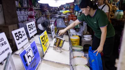 Spike in rice prices A vendor scoops rice at a Manila market as concerns grow over a 60-day rice import suspension starting 1 September. Stakeholders warned the ban could increase retail rice prices, citing reduced imported supply and rising local palay prices.