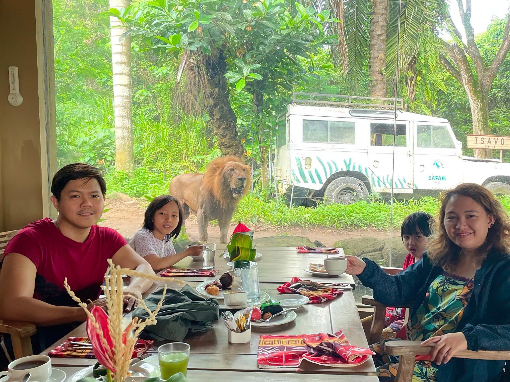 Bernardo family having breakfast with lions at Tsavo Lion Restaurant in Bali.