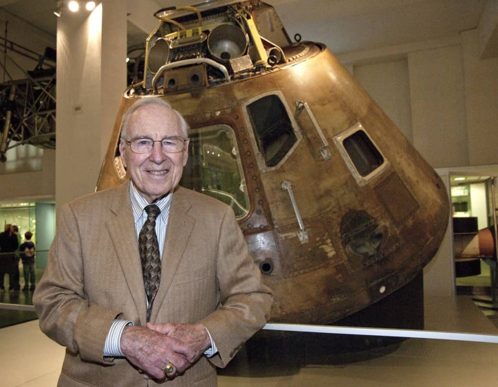 Astronaut Jim Lovell in front of the Apollo 10 Command Module at the Science Museum.