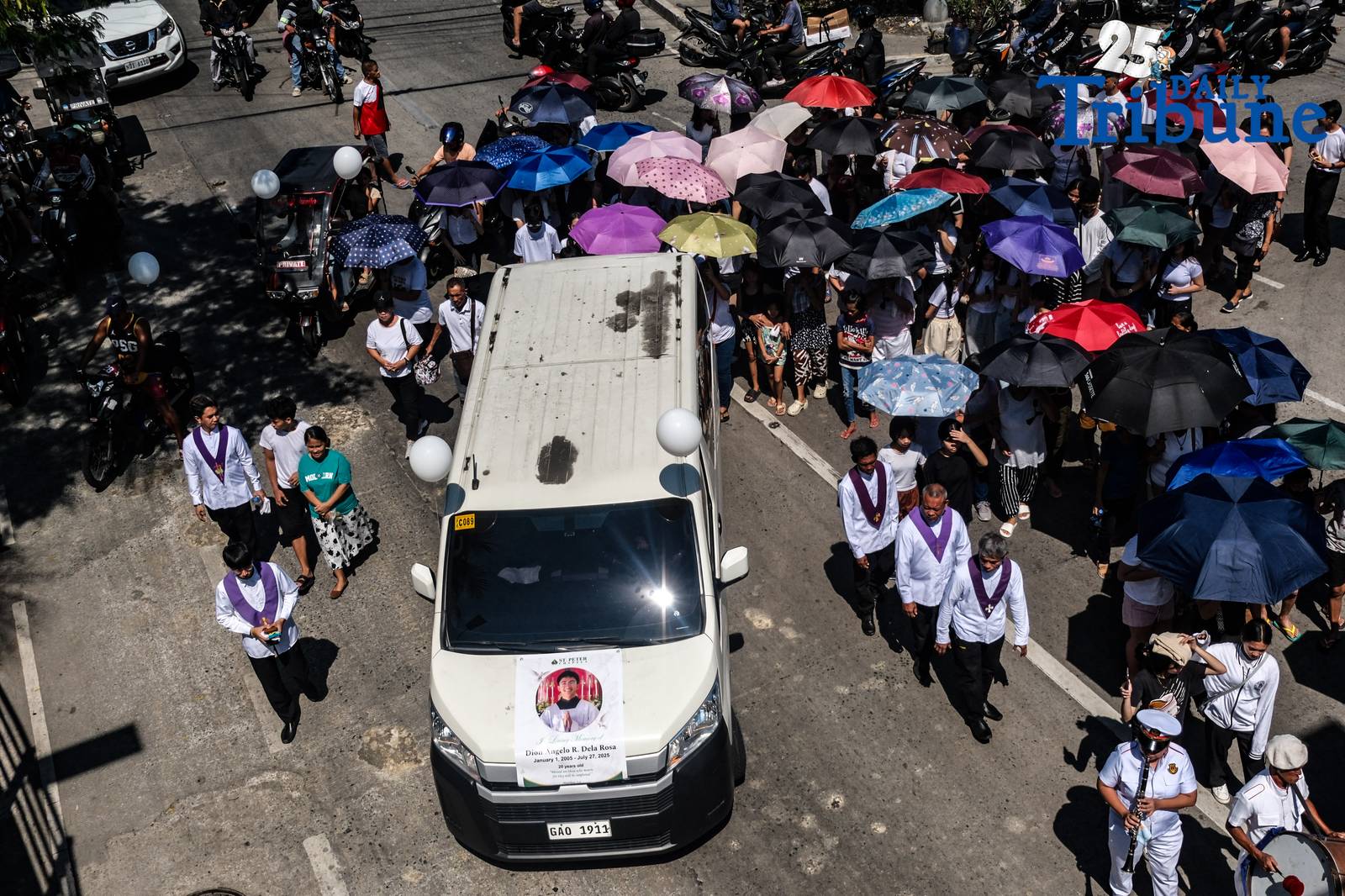Tears fell from members of the Nuestro Señor De Longos-Mission Station on Sunday, August 10, 2025, as Dion Gelo Dela Rosa, a 20-year-old sacristan, was laid to rest at Our Lady of Lourdes Eternal Park in Malabon City after dying of leptospirosis, which he contracted while wading through floodwaters in search of his missing father.

“Siya yung naghahanap sa akin nung nawala ako,” said Jayson Dela Rosa, 41, Gelo’s father. “Kasi pag hahanap niya, umuulan. Baha. Nagkaleptospirosis ilang araw lang. Nagkalagnat tapos yun na.”

Jayson had gone missing on July 22 after accompanying one of his children to a bus terminal in Caloocan, only to be detained without a warrant by local police for alleged street gambling. “Kasi nakulong ako. Maling paratang, maling sistema,” he said, recalling how the family was not informed of his arrest and only learned about it three days later.

The circumstances of Gelo’s death and Jayson’s detention have sparked public outrage and calls for justice. “Kaya, masakit… Kaya, sa simbahan, justice talaga,” the grieving father said after the burial rites.

He added that legal proceedings are underway. “Magkakaroon kami ng hearing… habulin namin yung matitama yung sistema.” Still, the family finds a bit of closure in the burial. “Kaya sapat na sa amin na malibing. Tapos balik sa hanap ng buhay. Balik trabaho.”

Jayson also hinted at outside pressures. “May mga moves… gusto akong kausapin, pero mali. Parang threat sa akin.” Despite this, he said, “Bahala na yung husgado.”