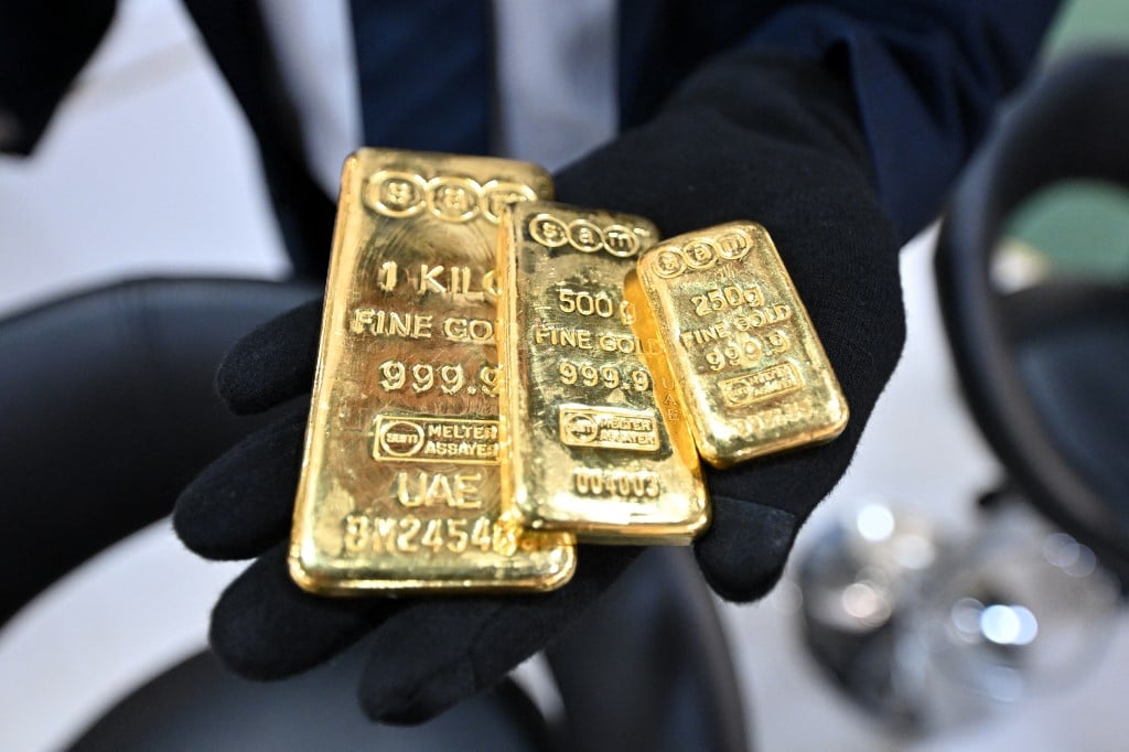 (FILES) A participant shows gold bars during the 21st edition of the international gold and jewellery exhibition at the Kuwait International Fairgrounds in Kuwait City on May 23, 2024. US President Donald Trump said on August 11, 2025 that gold imports will not face additional tariffs, days after confusion flared on whether recent hikes applied to certain gold bars -- threatening to upend global trade of the precious metal.