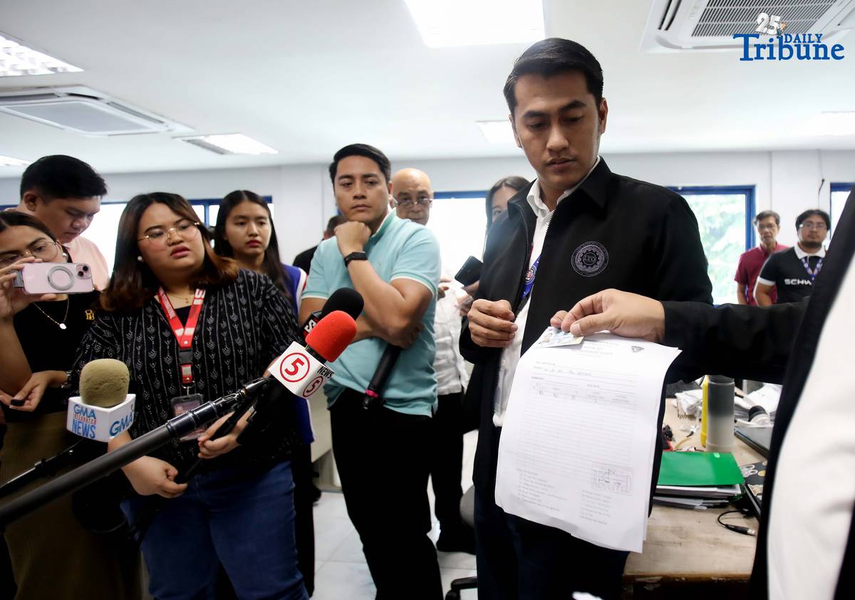 Land Transportation Office Executive Director Greg G. Pua Jr. shows members of the media the confiscated driver’s license after a preliminary hearing for Hyundai Kyona, who was caught driving against traffic (counterflow) along Skyway. The hearing was held at the LTO Main Office in Quezon City on Tuesday, August 12, 2025.