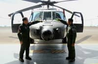 Philippine Air Force Air Mobility Command commander MGen. Ramil Oloroso (right) and PAF commander Lieutenant General Arthur Cordura lead the ceremonial pouring of champagne on the newly acquired S-70i Black Hawk helicopter on Wednesday at Clark Air Base, Mabalacat City, Pampanga.