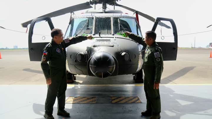 Philippine Air Force Air Mobility Command commander MGen. Ramil Oloroso (right) and PAF commander Lieutenant General Arthur Cordura lead the ceremonial pouring of champagne on the newly acquired S-70i Black Hawk helicopter on Wednesday at Clark Air Base, Mabalacat City, Pampanga.