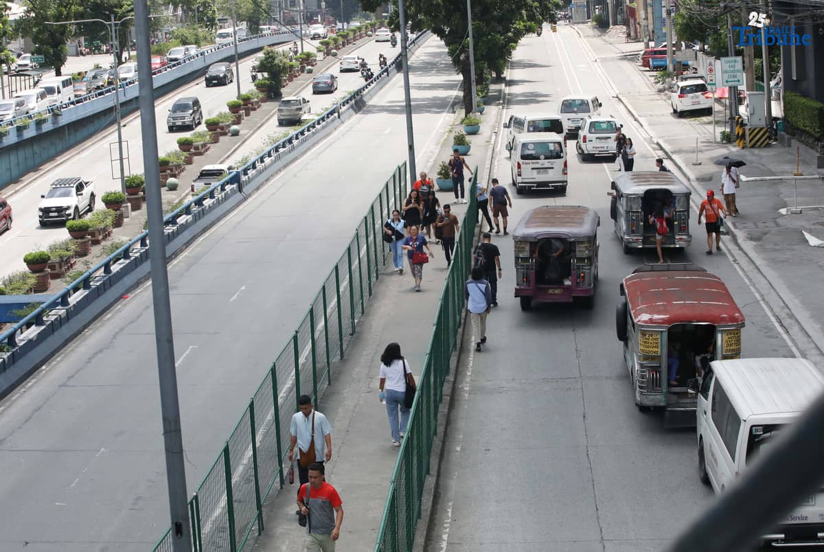 Motorists and commuters pass along Quezon Avenue in Quezon City on Thursday. The Department of Transportation said a feasibility study for a new busway connecting España Boulevard and Quezon Avenue is expected to be completed next year, with funding from the Asian Development Bank.