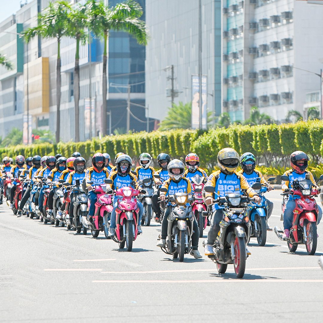 TVS scooter riders flash peace signs, capturing the fun and unity that keep the motorcycle scene alive.