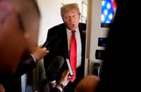 U.S. President Donald Trump speaks to members of the media aboard Air Force One on August 15, 2025, in flight. President Trump is traveling to Anchorage, Alaska, for peace talks with Russian President Vladimir Putin on the war with Ukraine.