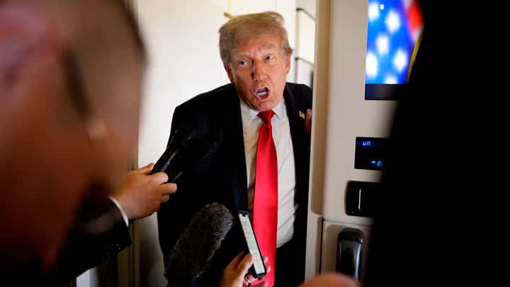 U.S. President Donald Trump speaks to members of the media aboard Air Force One on August 15, 2025, in flight. President Trump is traveling to Anchorage, Alaska, for peace talks with Russian President Vladimir Putin on the war with Ukraine.
