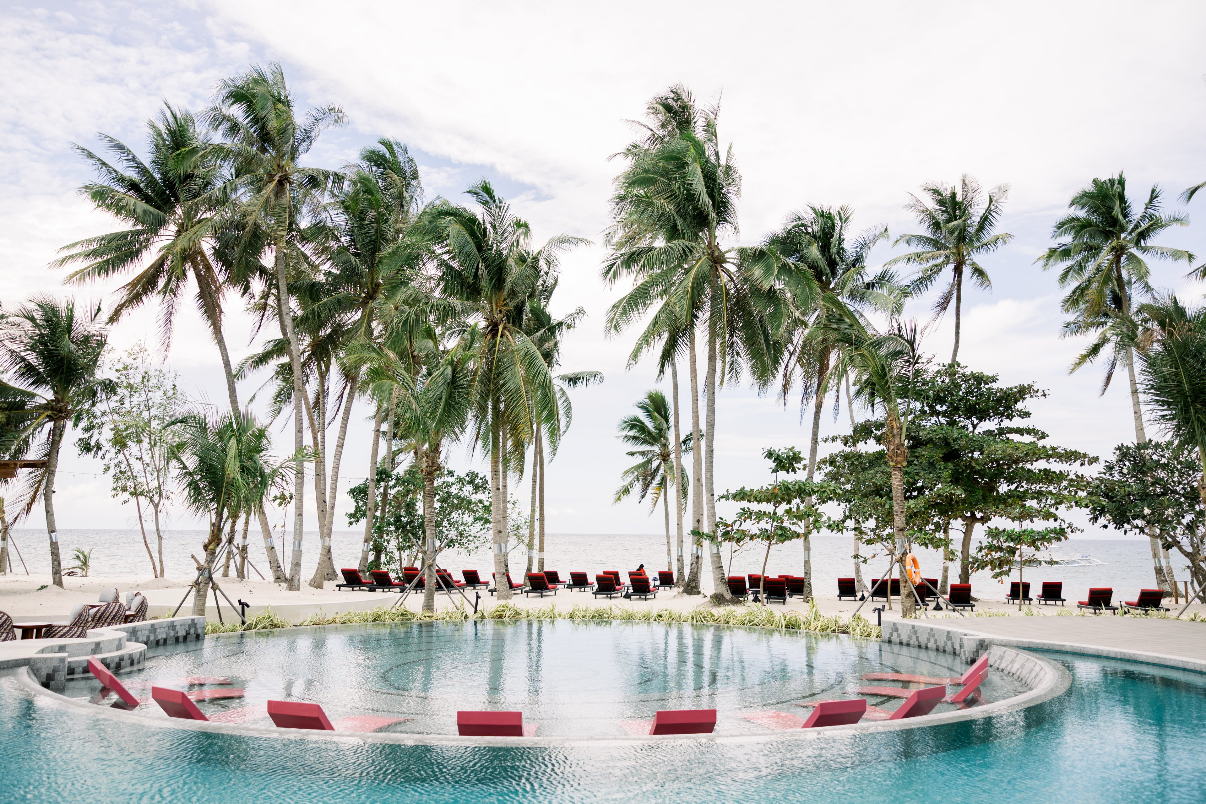 In the south of Panglao Island, the Philippines beach hotel is dotted with coconut palms and backed by tropical hills.