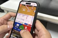 A customer plays an online gambling game on a mobile phone. Digital wallet providers GCash and Maya suspended in-app gaming access on 16 August in compliance with a Bangko Sentral ng Pilipinas directive.
