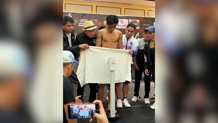 The handlers of Kenneth Llover cover the fighter with a towel after coming in 400 grams over the 118-pound agreed weight during official weighin Saturday at Winford Resort Casino.