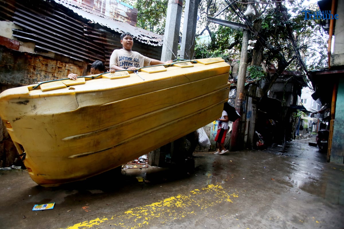Kids find joy in the rain on rescue boat in Caloocan