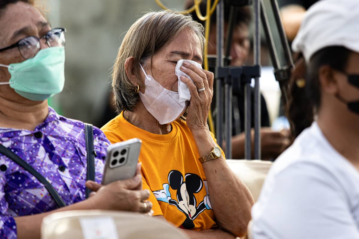 Weeping, a mother listens as the story of her son's death is being retold during the launch of the Justice for All campaign.