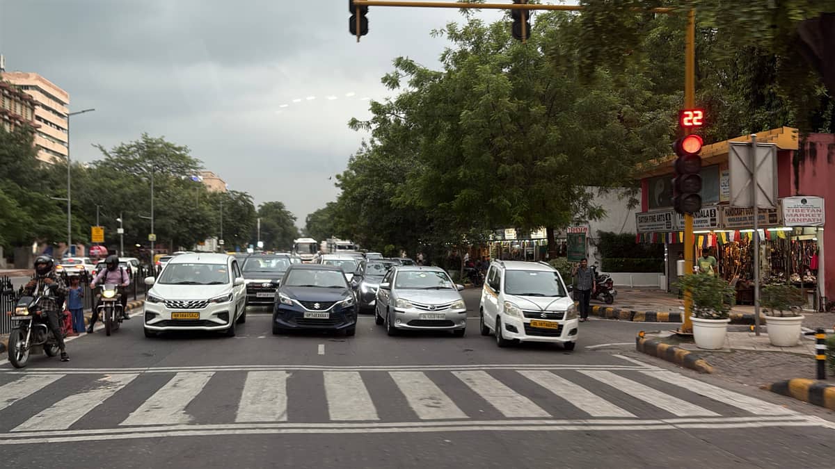 A TYPICAL scene of traffic stopped at a red light on a major highway in India.