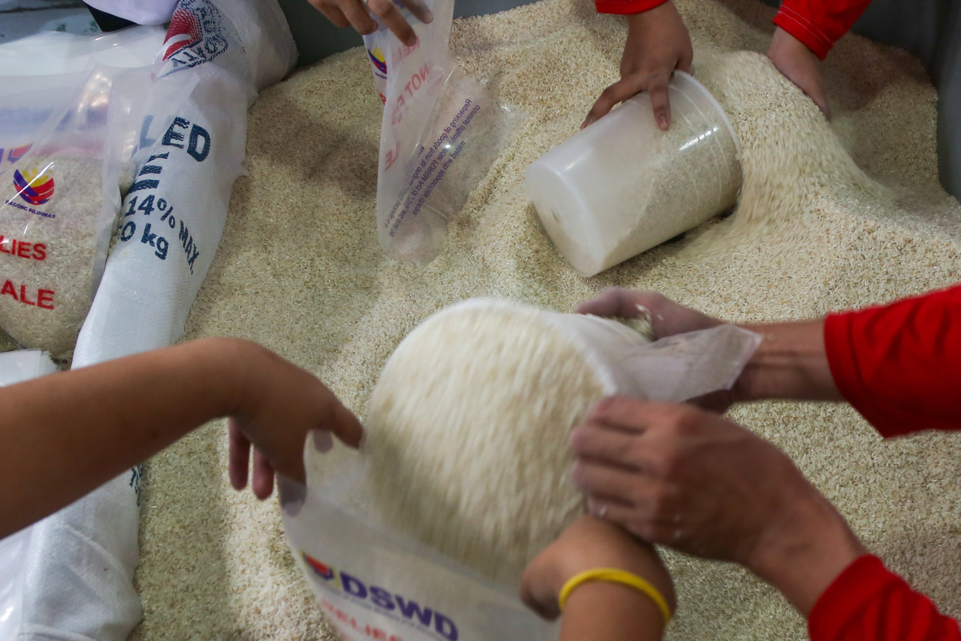 Volunteers pack food aid for families on World Humanitarian Day