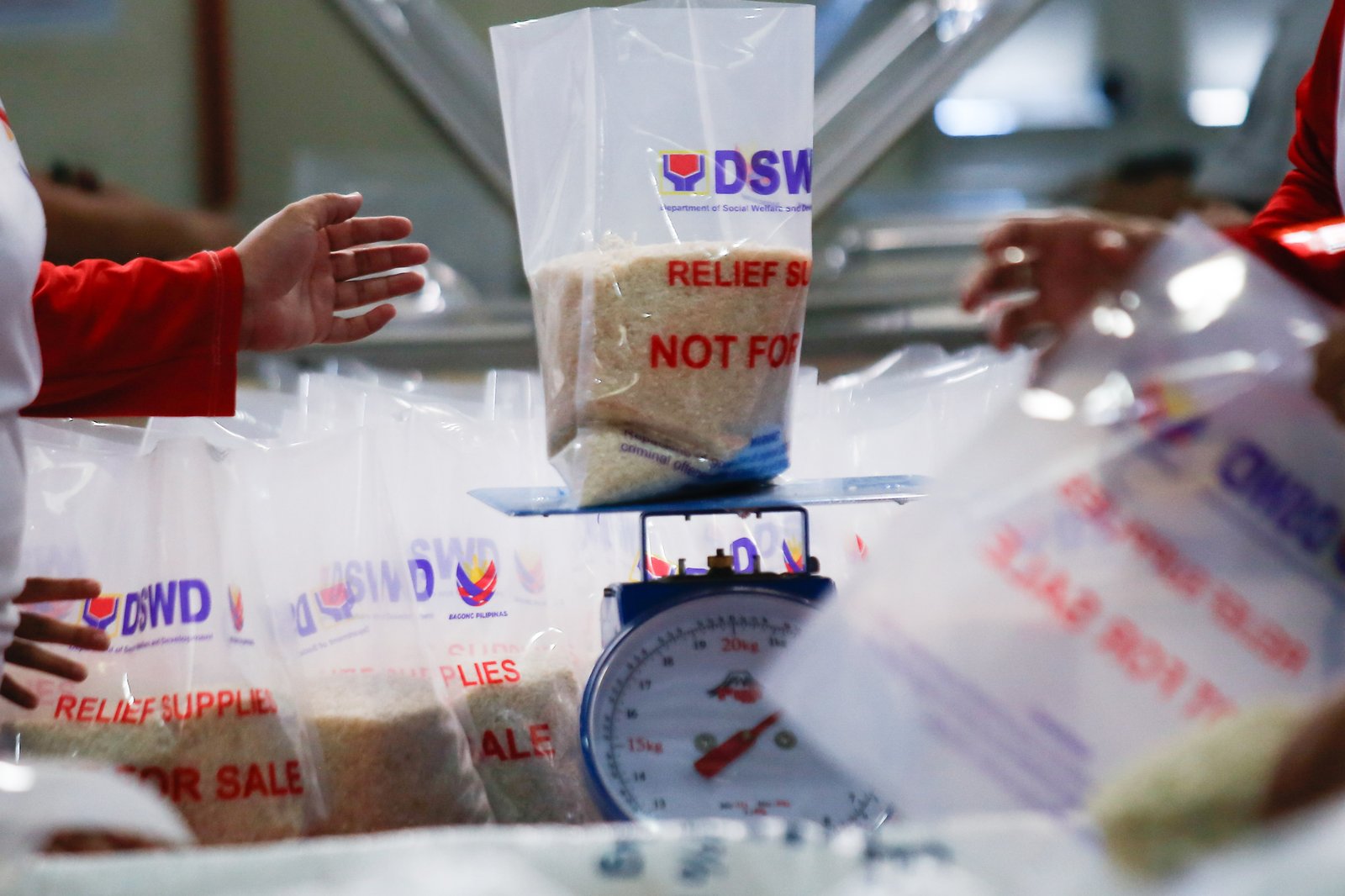 Volunteers and beneficiaries of the Tulong Panghanapbuhay sa Ating Disadvantaged Workers (TUPAD) program assemble Family Food Boxes at the Department of Social Welfare and Development warehouse in Parañaque City on World Humanitarian Day, August 19, 2025. Each food box, good for a family of five, contains 6 kilos of rice, 10 canned goods, 5 sachets of instant coffee, and 5 sachets of chocolate drinks. The initiative aims to support communities in need. World Humanitarian Day honors those who step into crises to help others.