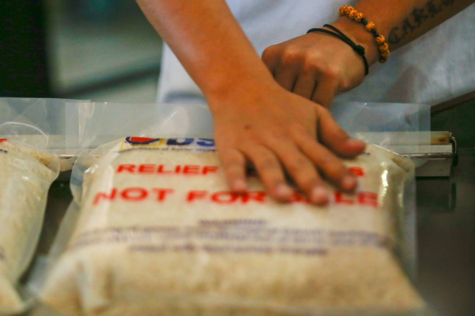 Volunteers and beneficiaries of the Tulong Panghanapbuhay sa Ating Disadvantaged Workers (TUPAD) program assemble Family Food Boxes at the Department of Social Welfare and Development warehouse in Parañaque City on World Humanitarian Day, August 19, 2025. Each food box, good for a family of five, contains 6 kilos of rice, 10 canned goods, 5 sachets of instant coffee, and 5 sachets of chocolate drinks. The initiative aims to support communities in need. World Humanitarian Day honors those who step into crises to help others.
